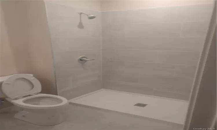 3rd Full Bathroom featuring tiled shower, tile flooring, and toilet