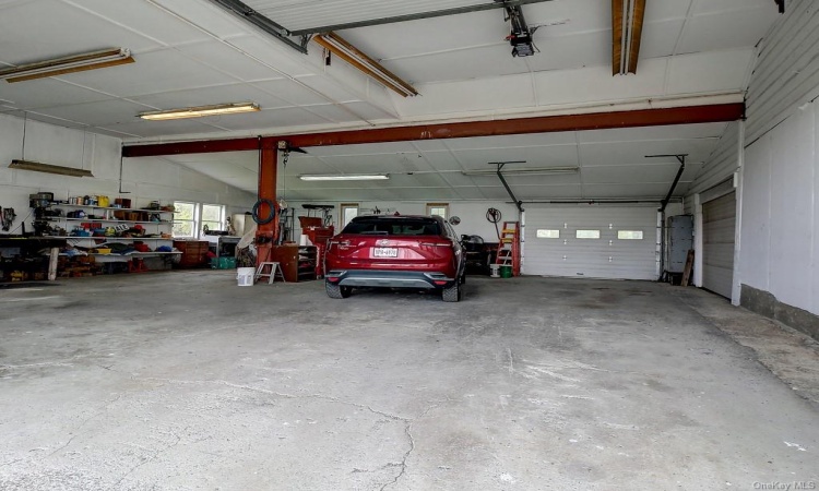 Oversized garage has electricity and workshop area.  Perfect for a car buff, carpenter and more.