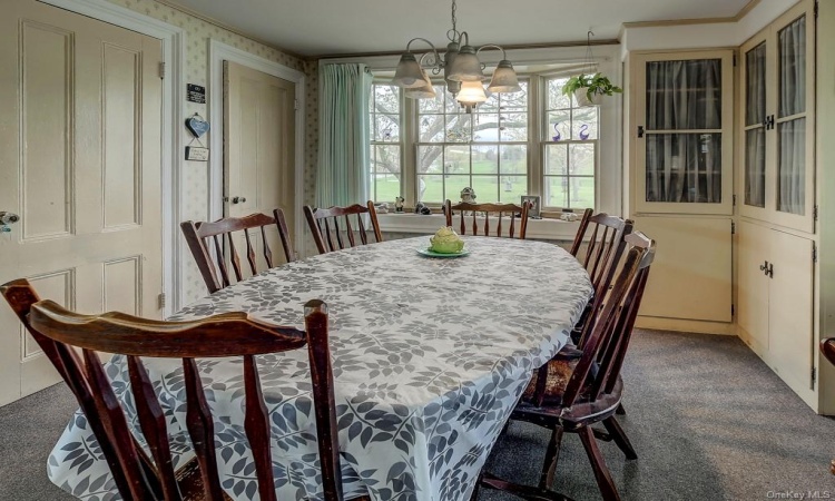 Light filled Country kitchen features built in china cabinets, and 2 pantries.  Note the original glass doorknobs and once again, beautiful property views.