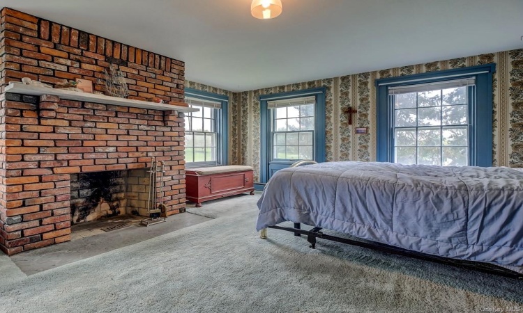 Full brick working fireplace in spacious master bedroom.  Note all of the natural light from large windows, to once again enjoy the gorgeous views.