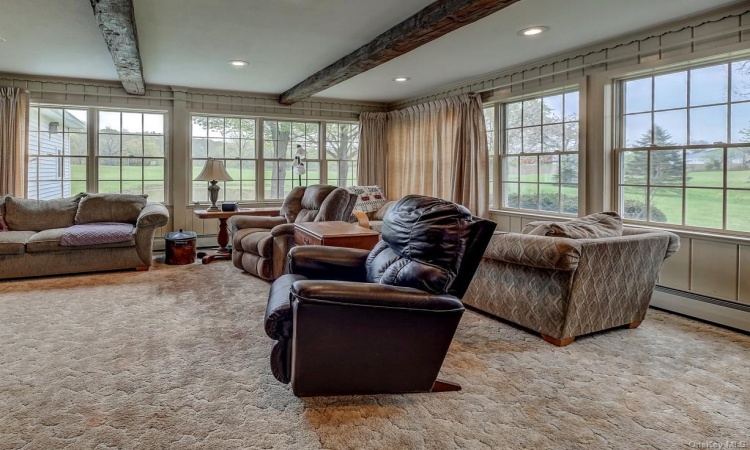 Everyone will love hanging out in this large great room.  Walls of windows just let all of the sunlight in.