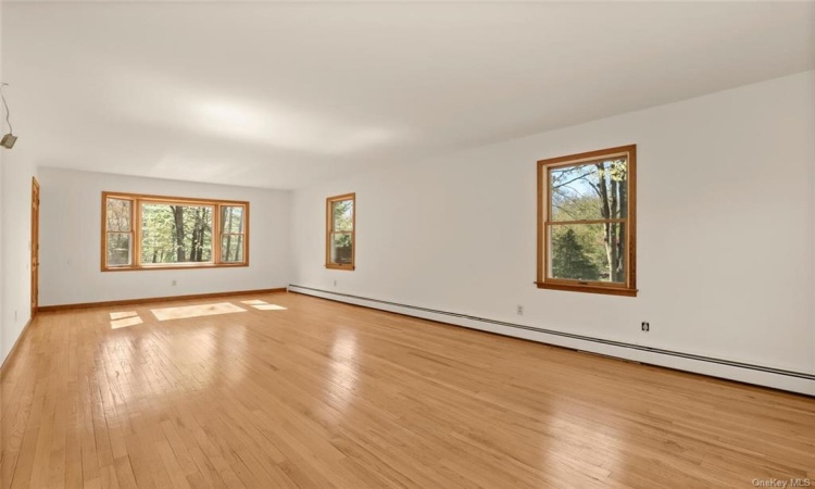 Spacious Formal Living Rooms with lots of windows and hardwood flooring.