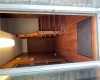 Hallway featuring wood walls and hardwood / wood-style floors