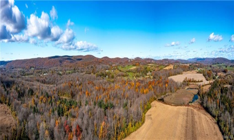 Panorama from middle field looking to the northwest. �The parcel offers multiple ponds, streams, well maintained trails, direct access to rail trail & productive land, perfect for organic farming, livestock, equestrian, recreational & sport.