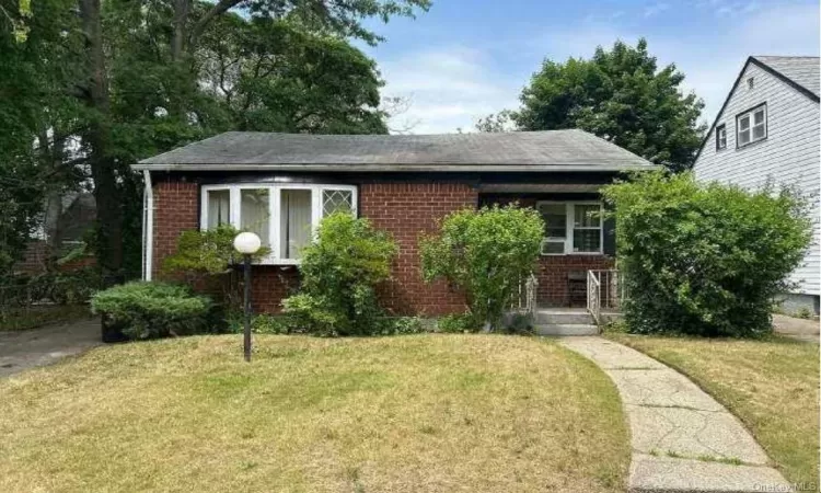 Bungalow-style home featuring a front yard