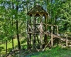 Rustic treehouse lends to property's natural setting.