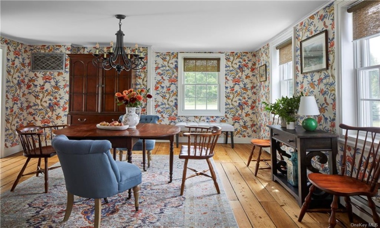 Formal dining room with original restored wide plank wood flooring.