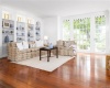 Formal living room w/two seating areas and French doors to the vintage brick patio surrounded by perennial gardens