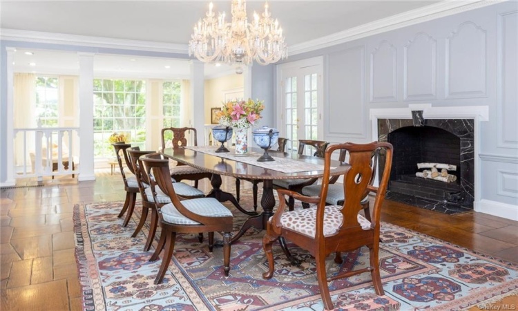 Formal dining  room w/original oak mosaic flooring and large fireplace. Open to the sunroom and the patio beyond.  Modelled after Montecello.