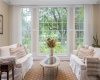 Two steps down from the dining room is this comfortable sunroom- perfect for breakfast, reading, etc.