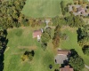 Home site is open field to the right. Pole barn in middle. Open acreage to left.