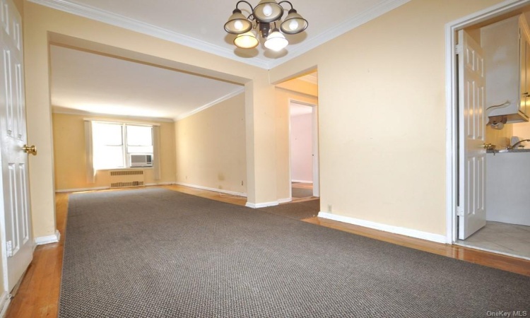 Dining foyer opens to the sunny living room has a closet and hardwood.