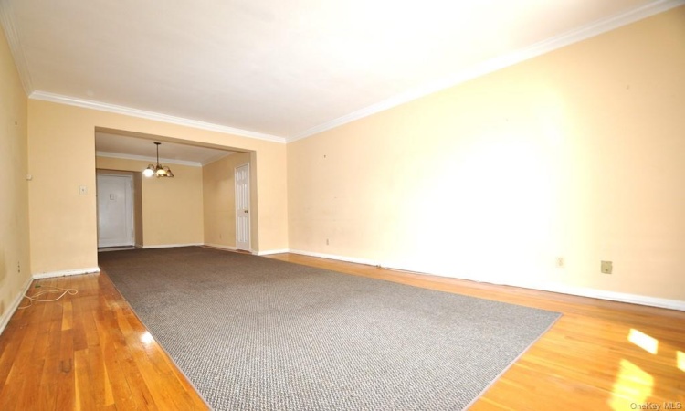 Large Living Room with hardwood floors opens to to the dining foyer.