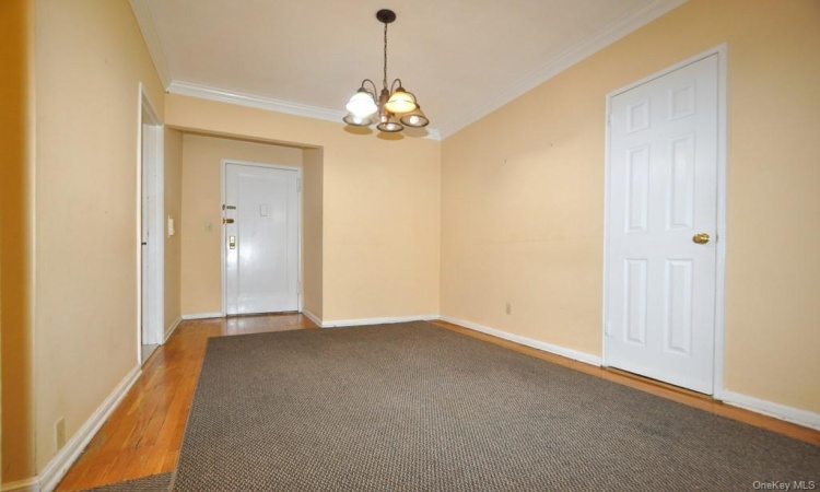 Dining foyer opens to the sunny living room has a closet and hardwood.