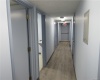 Hallway leading to reception area, kitchen/lab, exam rooms and private office.