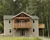 Rear view of house with a balcony