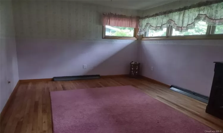 Spare room featuring hardwood / wood-style floors and a baseboard radiator