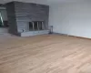 Unfurnished living room featuring a fireplace and light wood-type flooring