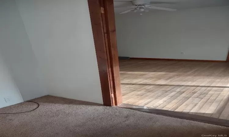 Carpeted spare room with ceiling fan