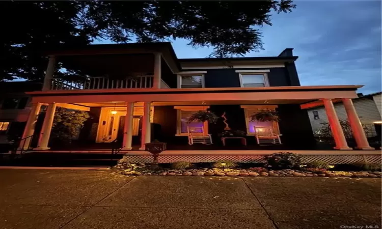 View of front of house with a porch and a balcony