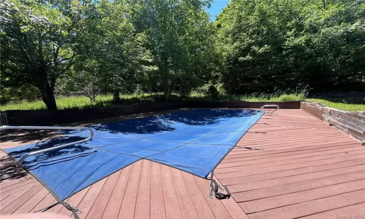 View of swimming pool with a deck