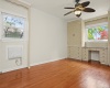 Large bedroom with many windows and built-ins.