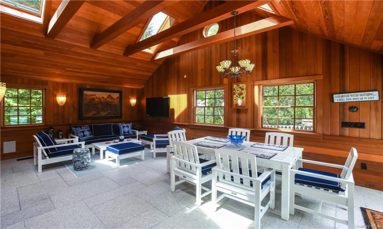 The pool house is its own private area with a kitchenette and large open area.