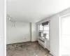 Kitchen featuring track lighting and concrete flooring