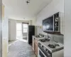 Kitchen with sink, stainless steel fridge, white range with gas cooktop, and radiator heating unit