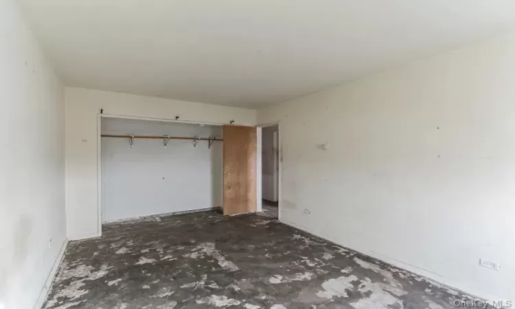 Unfurnished bedroom with a closet