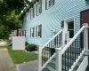 View of property exterior featuring a trex deck and a lawn