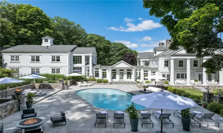 View of swimming pool featuring a fire pit, french doors, and a patio