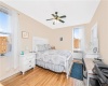 Primary bedroom with cross ventilation and ceiling fan