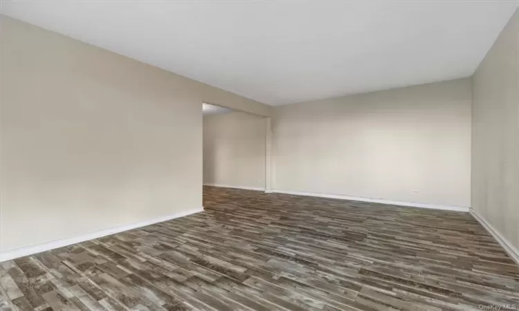 Spare room with dark hardwood / wood-style flooring