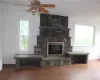 Unfurnished living room with hardwood / wood-style floors, ceiling fan, and plenty of natural light