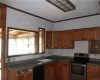 Kitchen featuring dishwasher, crown molding, sink, stainless steel range with electric cooktop, and a textured ceiling