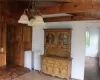 Unfurnished dining area with radiator heating unit, lofted ceiling with beams, a chandelier, and wooden ceiling