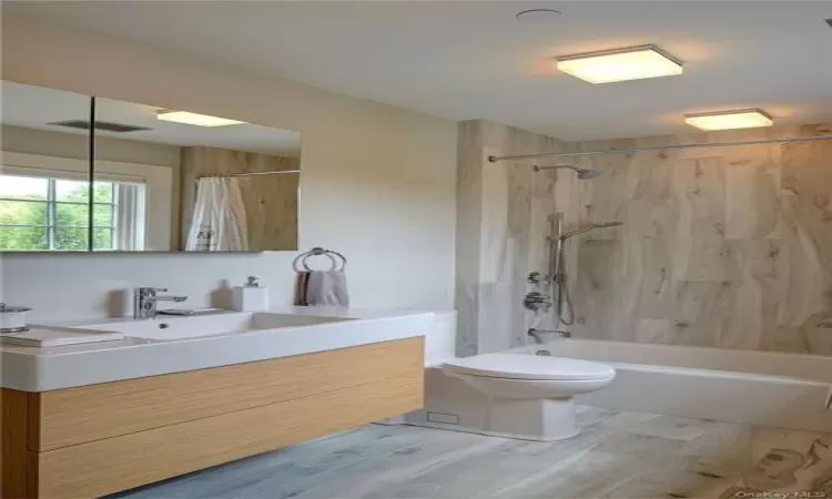 Bathroom with Duravit vanity, porcelain top, Hansgrohe fixtures, Italian porcelain floor