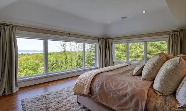 The primary bedroom with its large windows offers unparalleled views