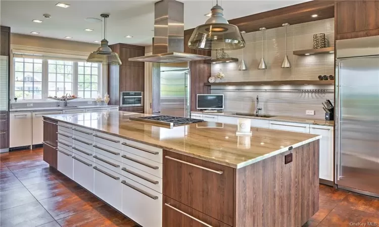 A modern chef's dream kitchen featuring top-of-the-line appliances and custom cabinetry