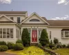 View of front of house with a front lawn and french doors