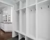 Mudroom with a glimpse of the generously-scaled butler's pantry with ample counter space and cabinetry.