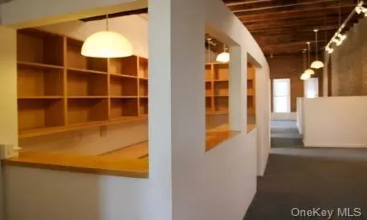 Corridor with carpet and high wood ceiling