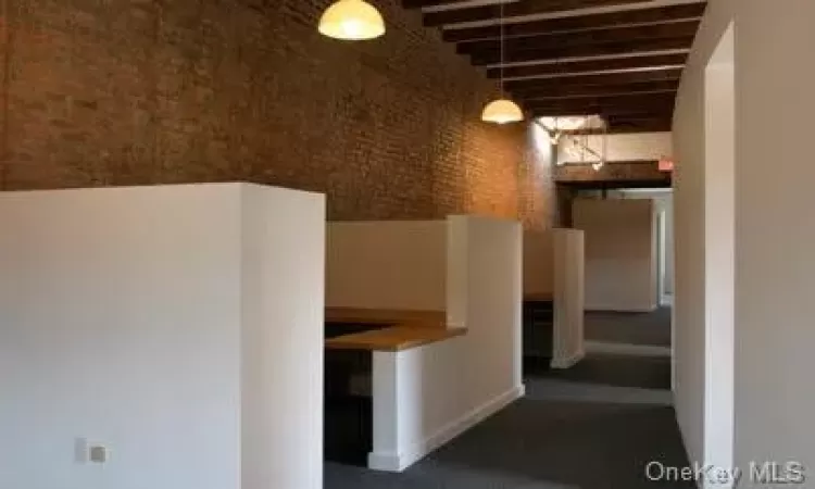 Partitioned private office area w/brick wall