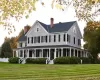 View of front of property with a front yard and a porch