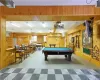 Rec room with tile flooring, wooden walls, and billiards