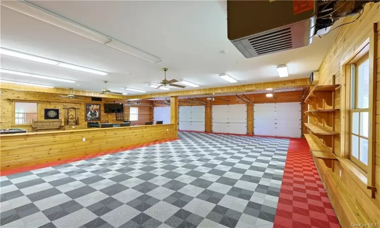 Garage with wooden walls and ceiling fan