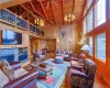 Living room with high vaulted ceiling, wood ceiling, wood walls, and hardwood / wood-style floors