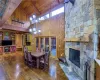 Dining room featuring wood walls, wooden ceiling, high vaulted ceiling, wood-type flooring, and beamed ceiling