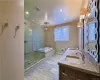 Bathroom featuring double vanity, independent shower and bath, and tile floors